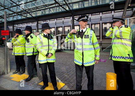 Metropolitan Police officers guard the entrance to UK Department for Business, Innovation and Skills during an Anti-Cuts protest, 1 Victoria Street, Central London, UK, on Monday 24th October, 2011. Stock Photo