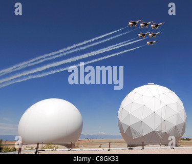 The Air Force Thunderbirds fly over Schriever Air Force Base, Colo., May 25. In the foreground are twin radomes of the Colorado Tracking Station, part of the Air Force Satellite Control Network. Stock Photo