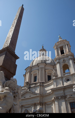 The 'Obelisk of Domitian' standing before the church of 'Sant'Agnese in Agone' a Baroque church in Piazza Navona, Rome, Italy. Stock Photo