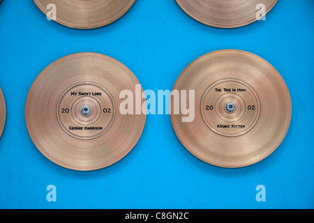Gold disks for George Harrison & Atomic Kitten on the Liverpool Wall of Fame on Mathew St Liverpool, Liverpool, England. Stock Photo