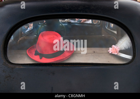 Red hat in rear window of 1930s Renault Celtaquatre, Vehicles of Interwar Poland Rally in Wroclaw, Lower Silesia, Poland Stock Photo