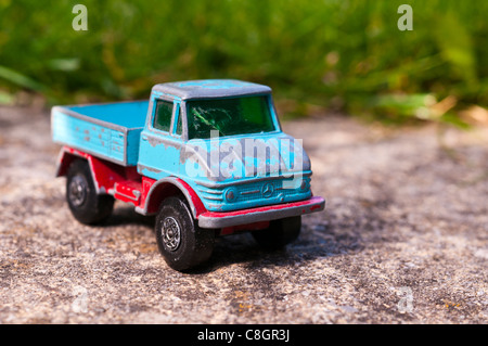 Old Mercedes Unimog toy in blue & red Stock Photo