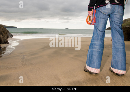 Womans legs on a beach in Pembrokeshire Stock Photo