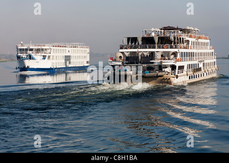Two cruise boats passing mid river on the Nile, Egypt Africa Stock Photo