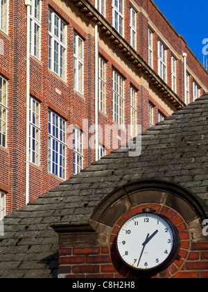Cadbury's chocolate factory in Bournville Birmingham England UK with clock on entrance gate Stock Photo