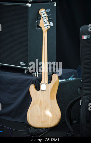 Fender bass electric guitar propped up against amplifier Brecon Jazz Festival 2011 Stock Photo