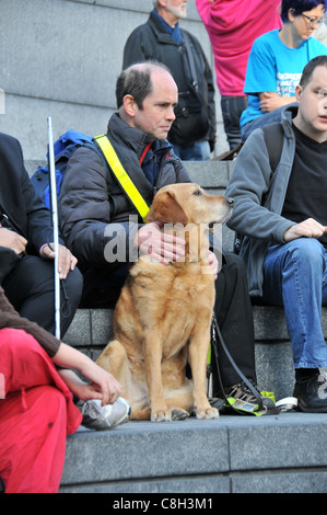 Blind man and guide dog Hardest Hit protest against benefit means test cuts for disabled people London Stock Photo