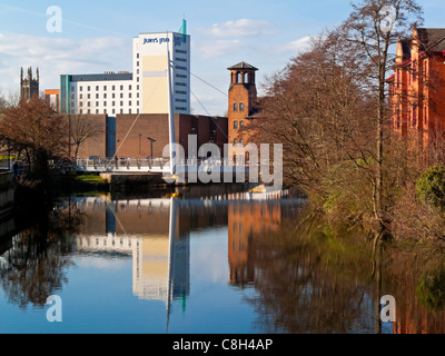 Derby Silk Mill on the River Derwent in Derbyshire built for the Lombe brothers between 1717 and 1721 and the city skyline Stock Photo