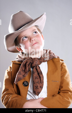 A funny young cowboy looking up with an attitude Stock Photo