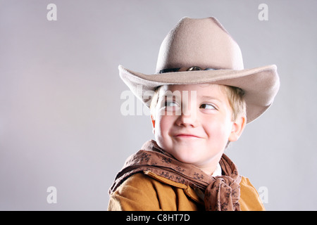 A young cowboy child smirking and looking to the right Stock Photo