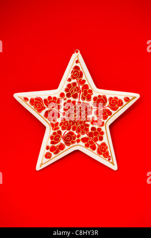 Papier-mâché star against a red background Stock Photo