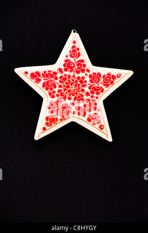 Papier-mâché star against a black background Stock Photo