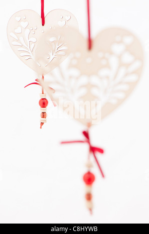 White heart-shaped decorations against a white background Stock Photo