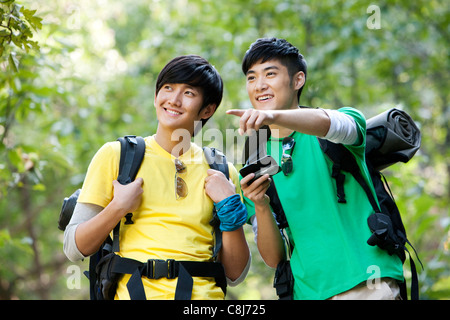 Hikers Using Mobile Phone With GPS Stock Photo