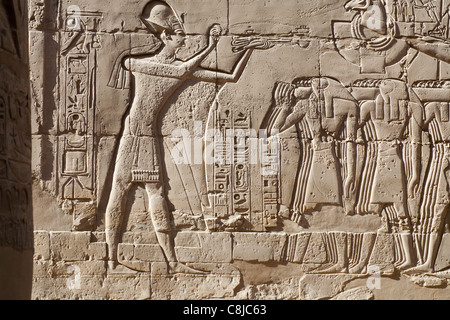 Relief work showing king Seti in blue crown censing the prow of the Barque of Amun at Karnak Temple, Luxor Egypt Stock Photo