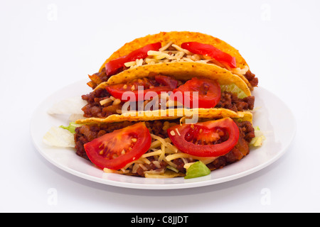 Delicious Mexican tacos on plate, isolated on white background. Stock Photo