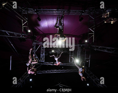 Suspended high wire artists practising with the Nofitstate Circus on tour in South Wales UK Stock Photo