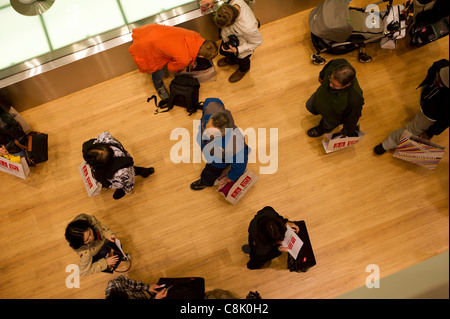 Customers shop at the grand opening of the Uniqlo store on West 34th street in New York Stock Photo