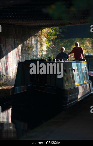 Boats go under a railway bridge on the Birmingham & Worcester canal at Selly Oak, Birmingham, UK. Stock Photo