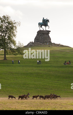 The Copper Horse, a statue of George III on horseback on snow hill, Windsor Great Park. A herd of deer. groups of people walking Stock Photo