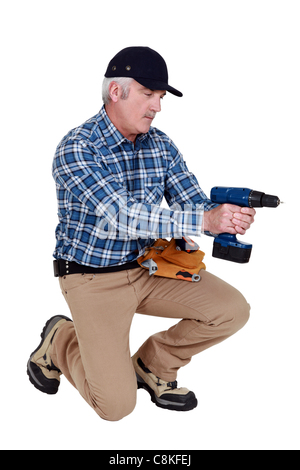 Grey haired man with drill Stock Photo