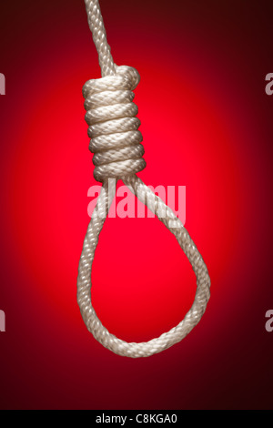 Hangman's Noose Over Red Spot Lit Background. Stock Photo