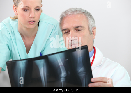 Doctor and nurse looking at an leg xray Stock Photo