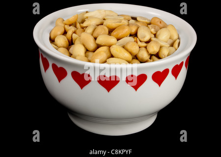picture of a bunch of peanuts in a heart bowl Stock Photo