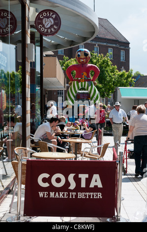 A Costa coffee shop with people sitting outside in the town centre. Stock Photo