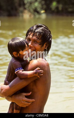 A-ukre village, Brazil. Bengoti Kayapo with his child Gordon Kayapo; Xingu Indigenous Area, Para State. Stock Photo