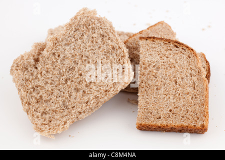 Halved wholemeal breadcake and a halved slice of wholemeal bread Stock Photo