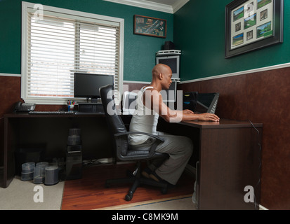 Black man working at desk in home office Stock Photo