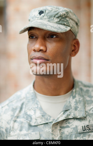 Close-up of soldier in military uniform with weapon on black background ...