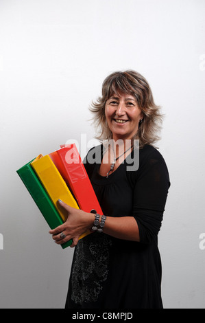 Female office worker holding file folders on ring binders Stock Photo