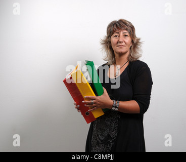 Female office worker holding file folders on ring binders Stock Photo