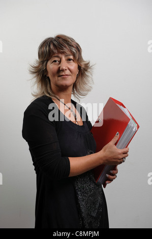 Female office worker holding file folders on ring binders Stock Photo