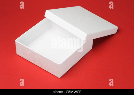 Open and empty white gift box on red background Stock Photo