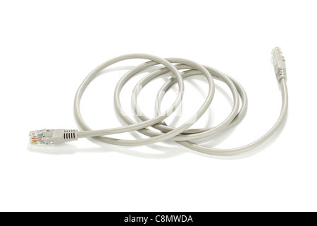 Network cable and plugs lying on white background Stock Photo