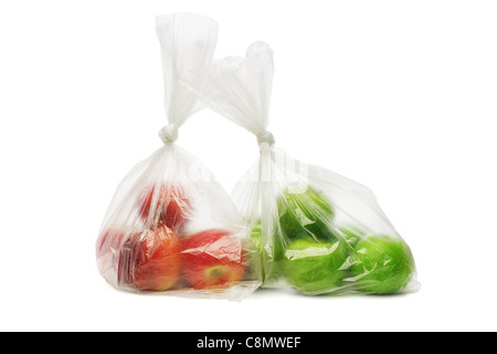 Two plastic bags of red and green apples on white background Stock Photo