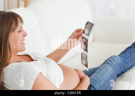 Attractive pregnant woman looking at a sonography Stock Photo