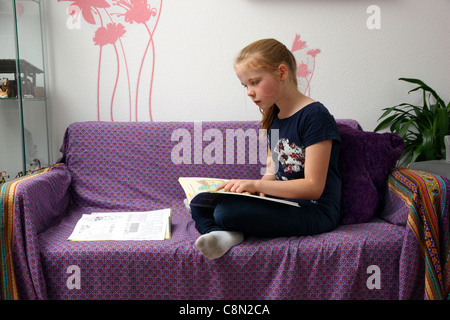 Girl, 10 years old, learning for school, at home in her room, doing homework. Stock Photo