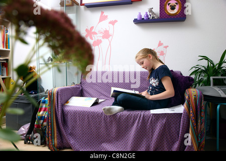 Girl, 10 years old, learning for school, at home in her room, doing homework. Stock Photo