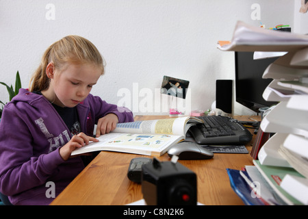 Girl, 10 years old, learning for school, at home in her room, doing homework. Stock Photo