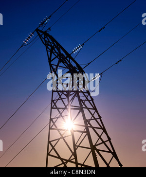 Sun setting behind a electrical transmission tower Stock Photo