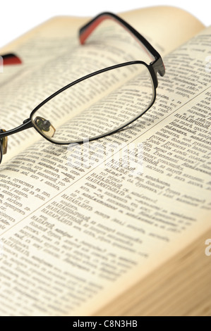Eyeglasses on the old thick book. A photo close up Stock Photo