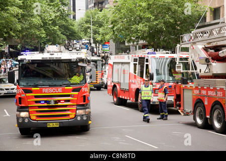 Four fire brigade engines wait in hunter street to see if a fire or danger is present,sydney,australia Stock Photo