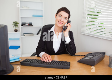 Young secretary answering the phone Stock Photo