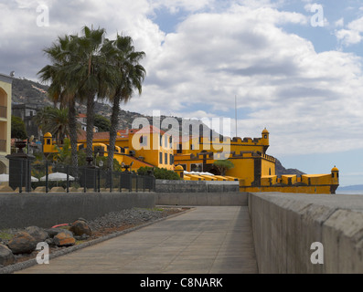 Looking along the seafront promenade towards the Fort Fortaleza de Sao Tiago Funchal Madeira Portugal EU Europe Stock Photo