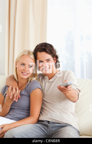 Portrait of a couple watching TV Stock Photo