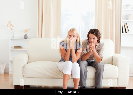 Couple watching a movie on TV Stock Photo